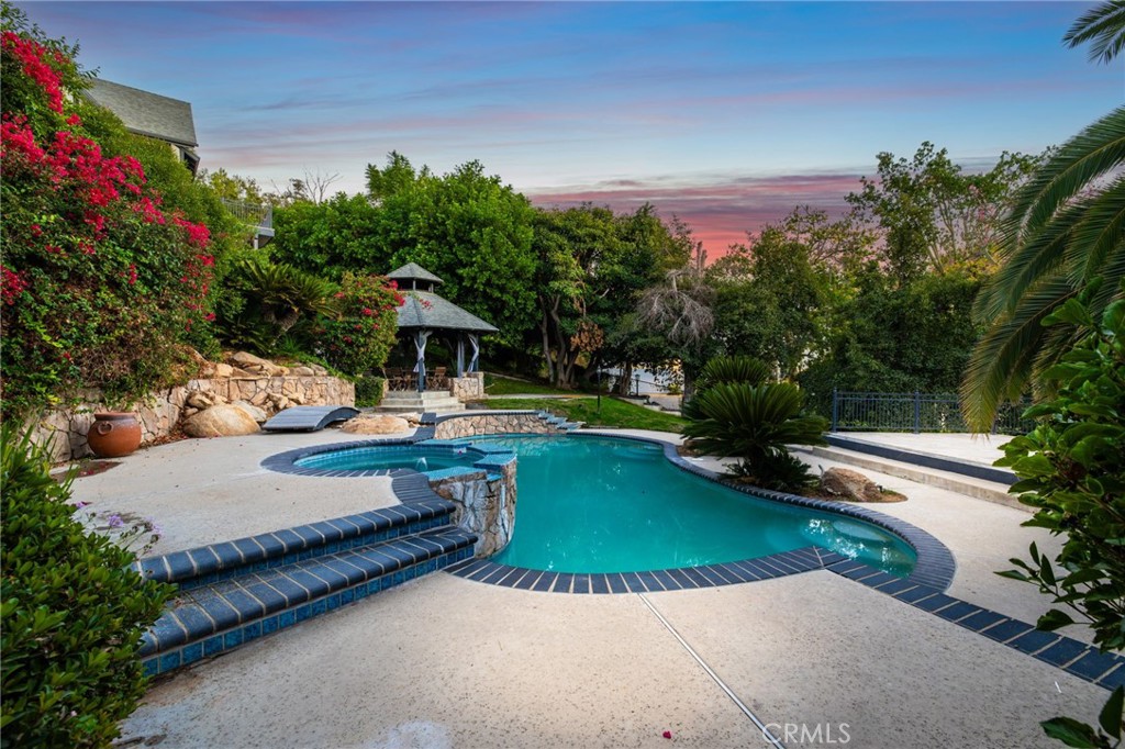 7008 Hawarden Drive Riverside, CA 92506 - Photo 8 of 37 a view of a swimming pool with a patio