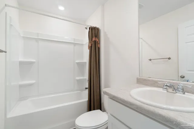 a bathroom with a granite countertop sink