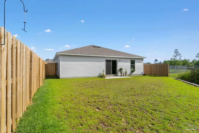 a front view of house with yard and outdoor seating