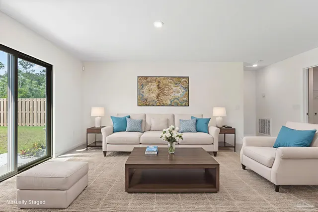 a living room with furniture and a large window