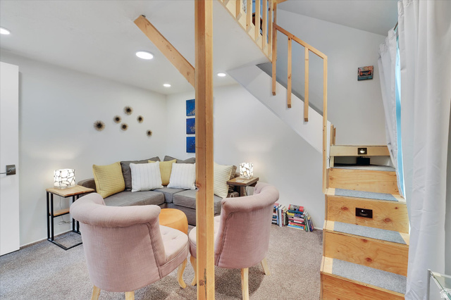 510 Spring Creek Road Providence, UT 84332 - Photo 18 of 97 Carpeted living area featuring recessed lighting, a built-in wooden staircase with integrated lighting, and a white interior door with dark hardware