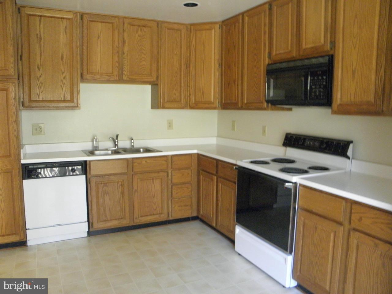 1900 Westchester Drive Silver Spring, MD 20902 - Photo 13 of 21 a kitchen with a sink stove and microwave