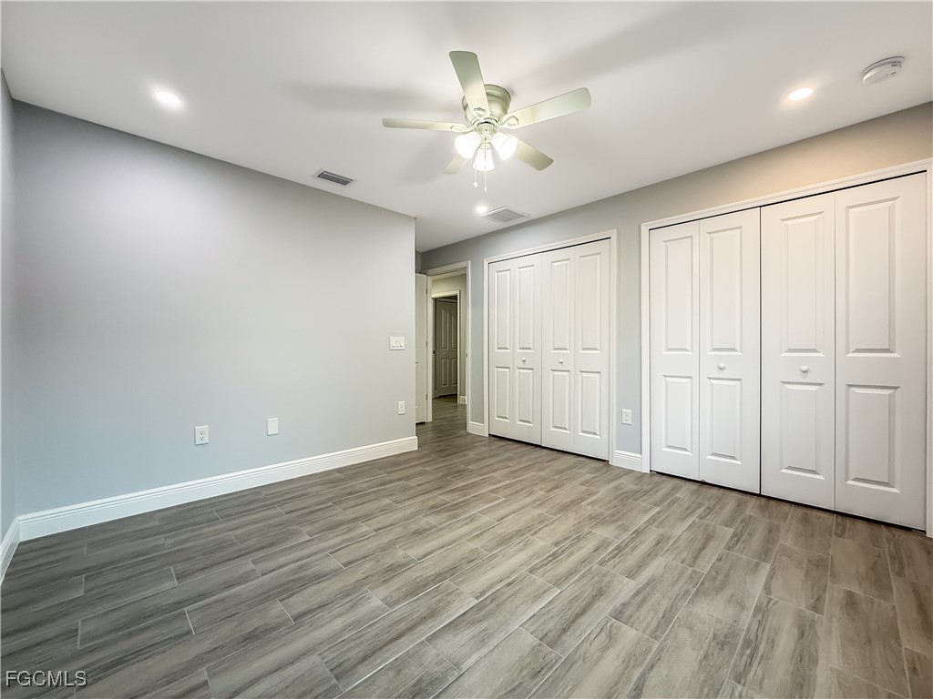 2955 Dunbar Street, Unit A B Fort Myers, FL 33916 - Photo 16 of 19 an empty room with wooden floor and windows
