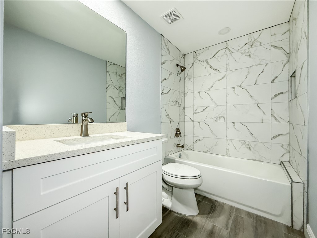 2955 Dunbar Street, Unit A B Fort Myers, FL 33916 - Photo 18 of 19 a bathroom with a sink toilet and shower