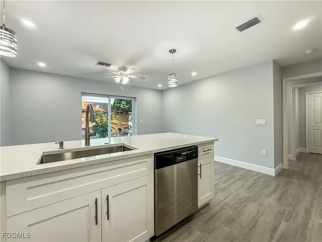 a kitchen with a sink and a stove top oven