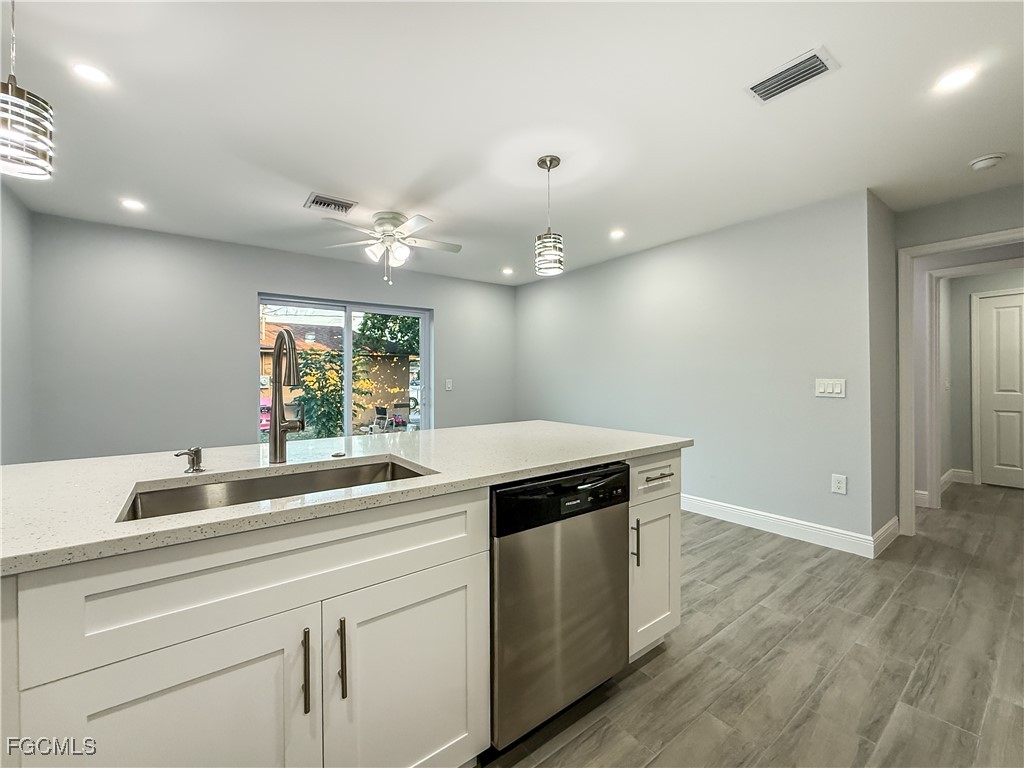 2955 Dunbar Street, Unit A B Fort Myers, FL 33916 - Photo 8 of 19 a kitchen with a sink and a stove top oven