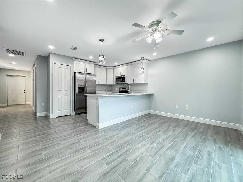 2955 Dunbar Street, Unit A B Fort Myers, FL 33916 - Photo 9 of 19 a view of kitchen with cabinets appliances and wooden floor