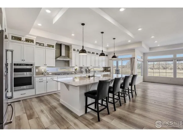 a large kitchen with a table and chairs