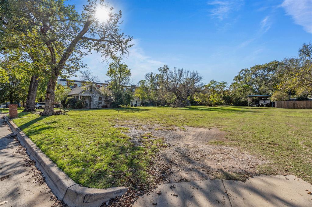 126 Athenia Drive Fort Worth, TX 76114 - Photo 4 of 21 a view of a garden with a building in the background