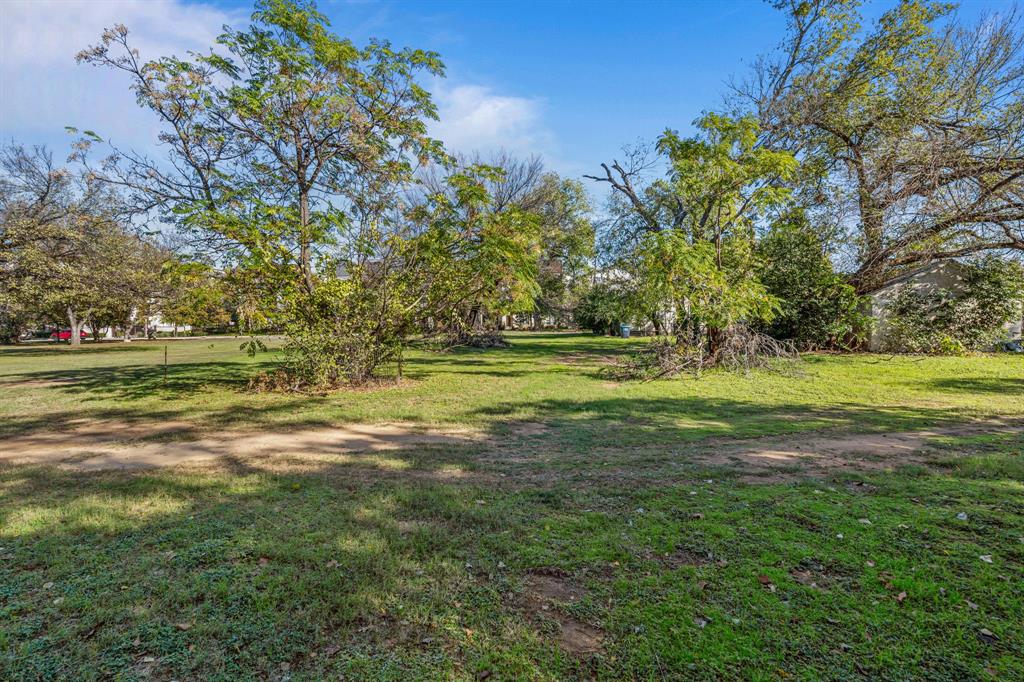 126 Athenia Drive Fort Worth, TX 76114 - Photo 10 of 21 a view of a grassy field with trees
