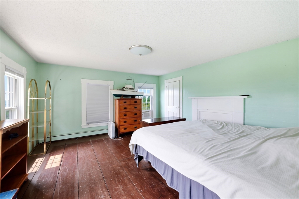 233 Ragged Hill Road West Brookfield, MA 01585 - Photo 24 of 42 a bedroom with a bed and wooden floor
