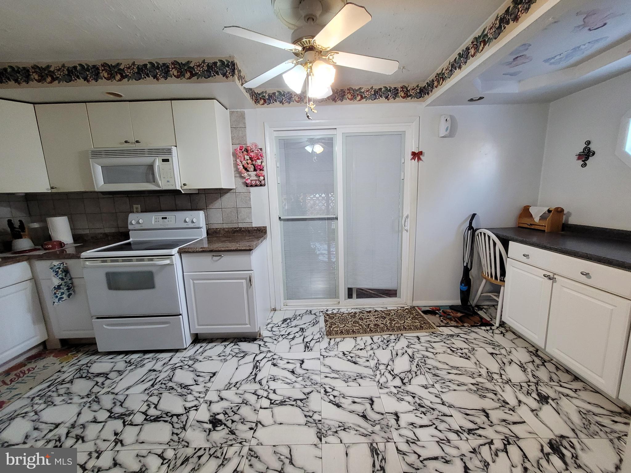 15 Shepherd Road Cherry Hill, NJ 08034 - Photo 7 of 21 a kitchen with a stove a sink and a refrigerator