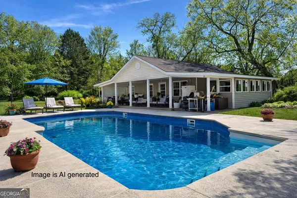 a view of a house with swimming pool and sitting area