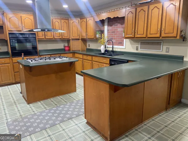a kitchen with stainless steel appliances granite countertop a sink and a cabinets