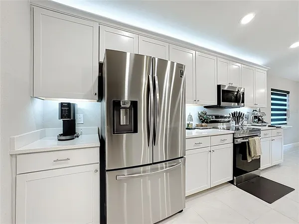a kitchen with a refrigerator sink and microwave