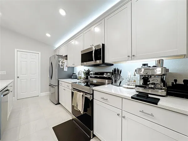 a kitchen with a sink cabinets and stainless steel appliances