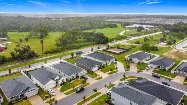 an aerial view of residential houses with outdoor space