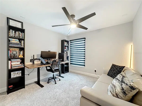 a view of a livingroom with workspace and a window