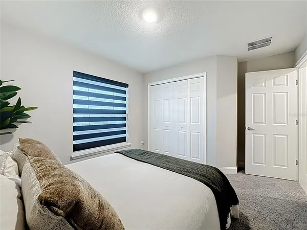 a bedroom with a bed and a closet