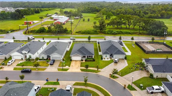 an aerial view of swimming pool with outdoor seating and city view