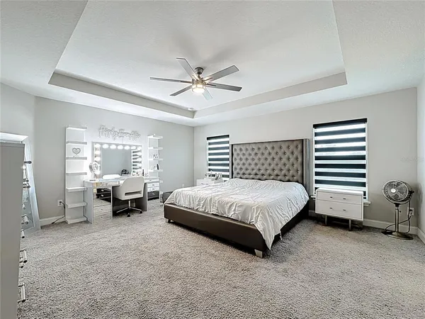 a spacious bedroom with a bed and a couch