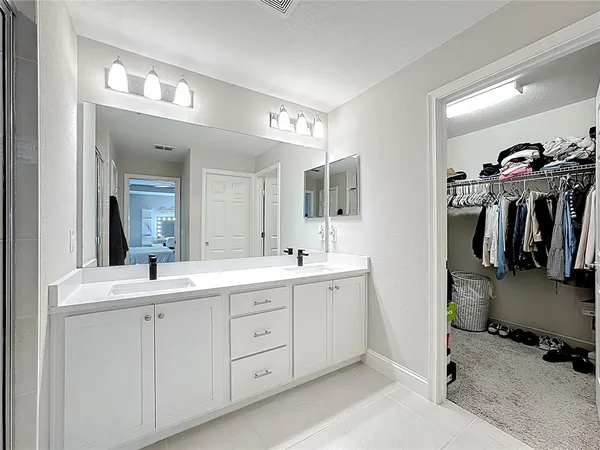 a bathroom with a double vanity sink and a mirror