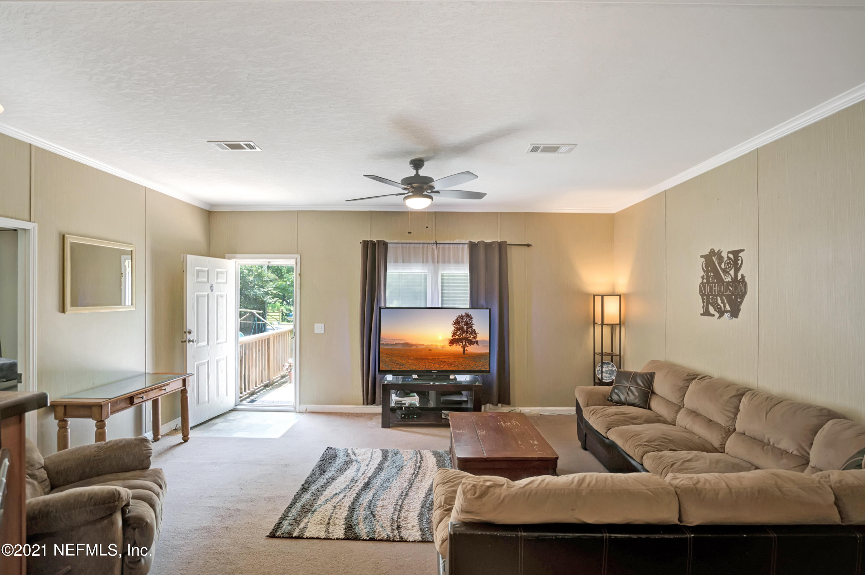 13295 Pate Road West Jacksonville, FL 32226 - Photo 6 of 31 a living room with furniture and a flat screen tv