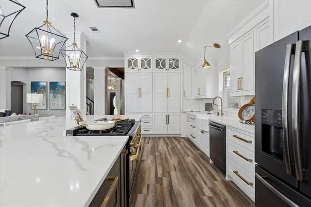 a kitchen with a sink stove and refrigerator