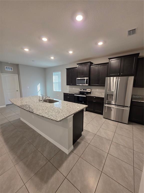 8059 Southwest 57th Court Ocala, FL 34476 - Photo 13 of 36 a large kitchen with a large counter top appliances and cabinets