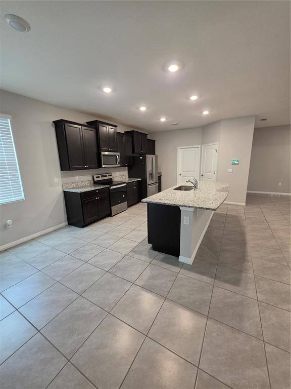 8059 Southwest 57th Court Ocala, FL 34476 - Photo 15 of 36 a large white kitchen with a large window and stainless steel appliances