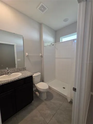 a bathroom with a sink a toilet and mirror