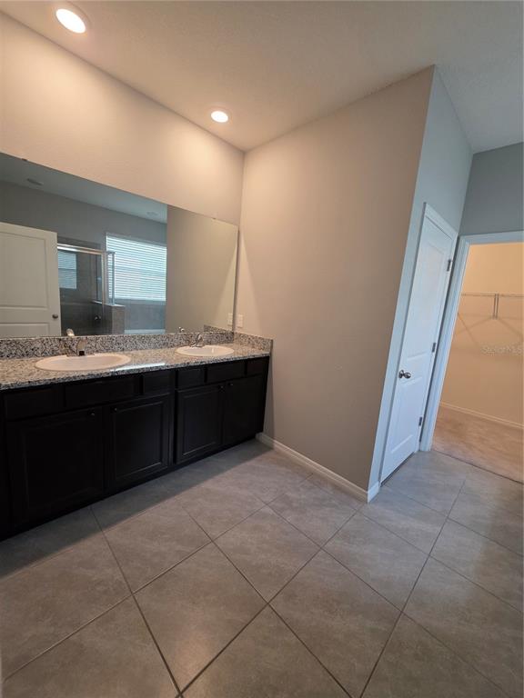 8059 Southwest 57th Court Ocala, FL 34476 - Photo 25 of 36 a bathroom with a sink and a mirror