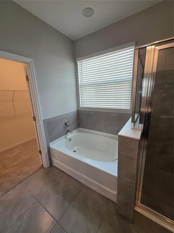 a white toilet sitting next to a shower