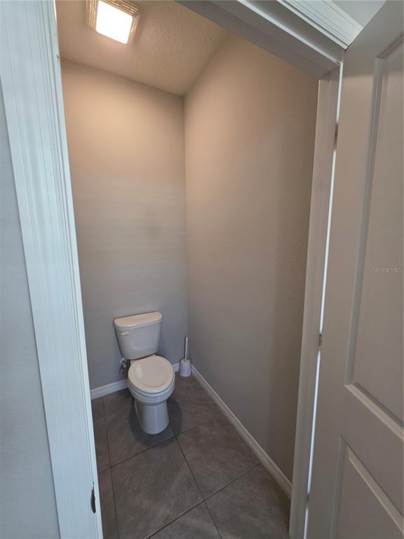 8059 Southwest 57th Court Ocala, FL 34476 - Photo 29 of 36 a white toilet sitting next to a shower