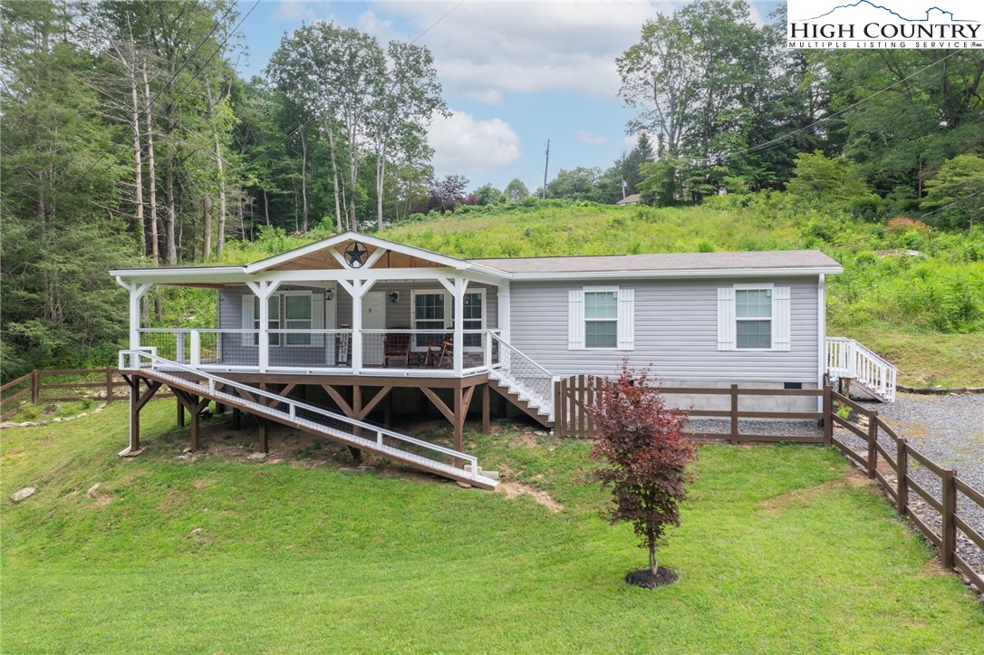 a front view of house with yard and outdoor seating