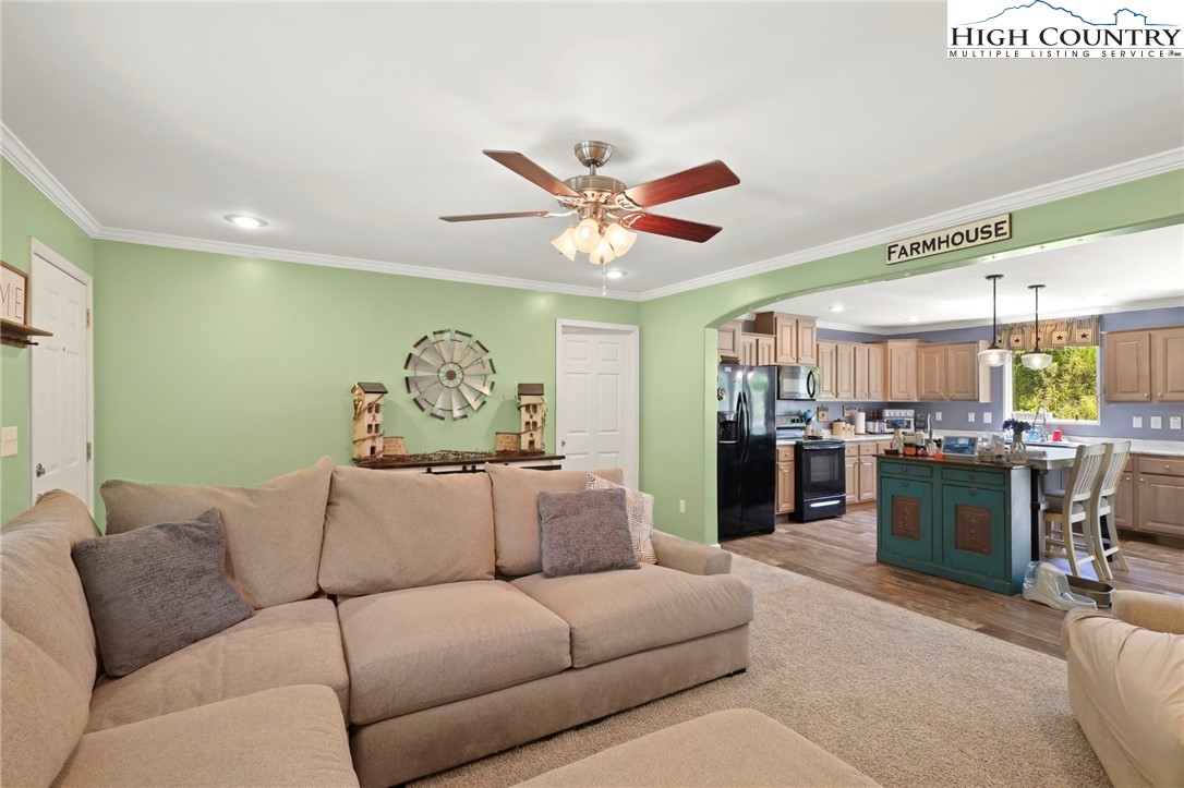 565 Valley Road Spruce Pine, NC 28777 - Photo 12 of 39 a living room with furniture a fireplace and a ceiling fan