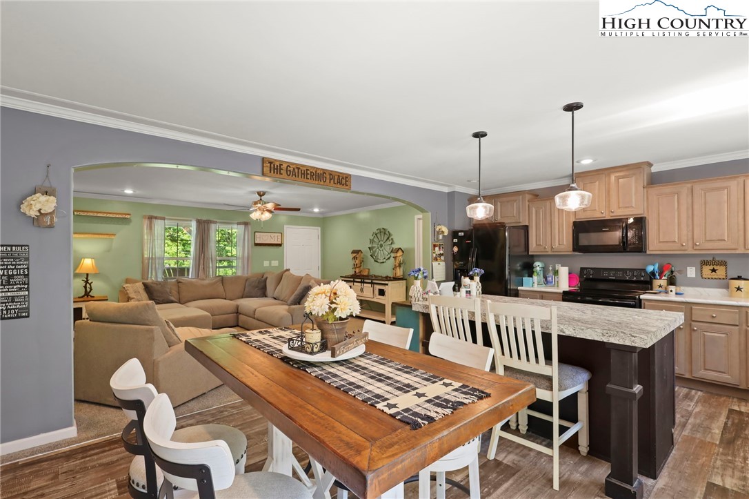 565 Valley Road Spruce Pine, NC 28777 - Photo 14 of 39 a dining room with furniture a rug and wooden floor