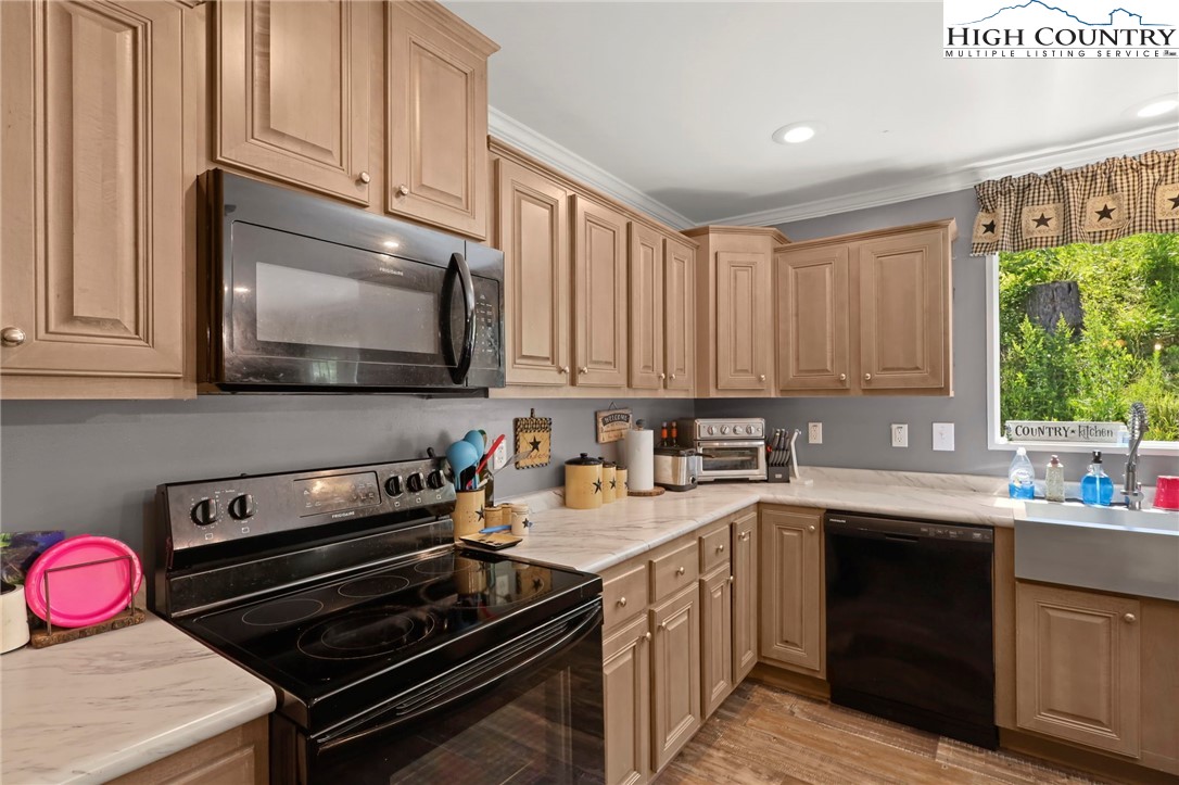 565 Valley Road Spruce Pine, NC 28777 - Photo 18 of 39 a kitchen with a sink stove top oven and cabinets