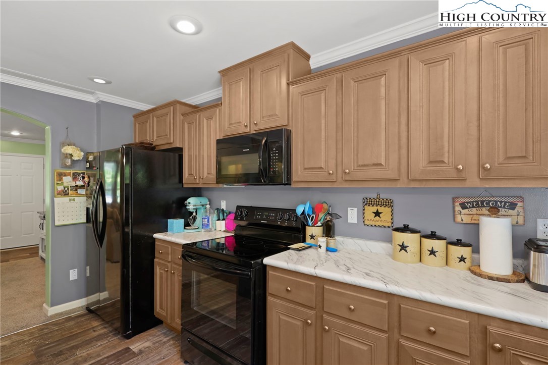 565 Valley Road Spruce Pine, NC 28777 - Photo 19 of 39 a kitchen with stainless steel appliances granite countertop a refrigerator sink and cabinets