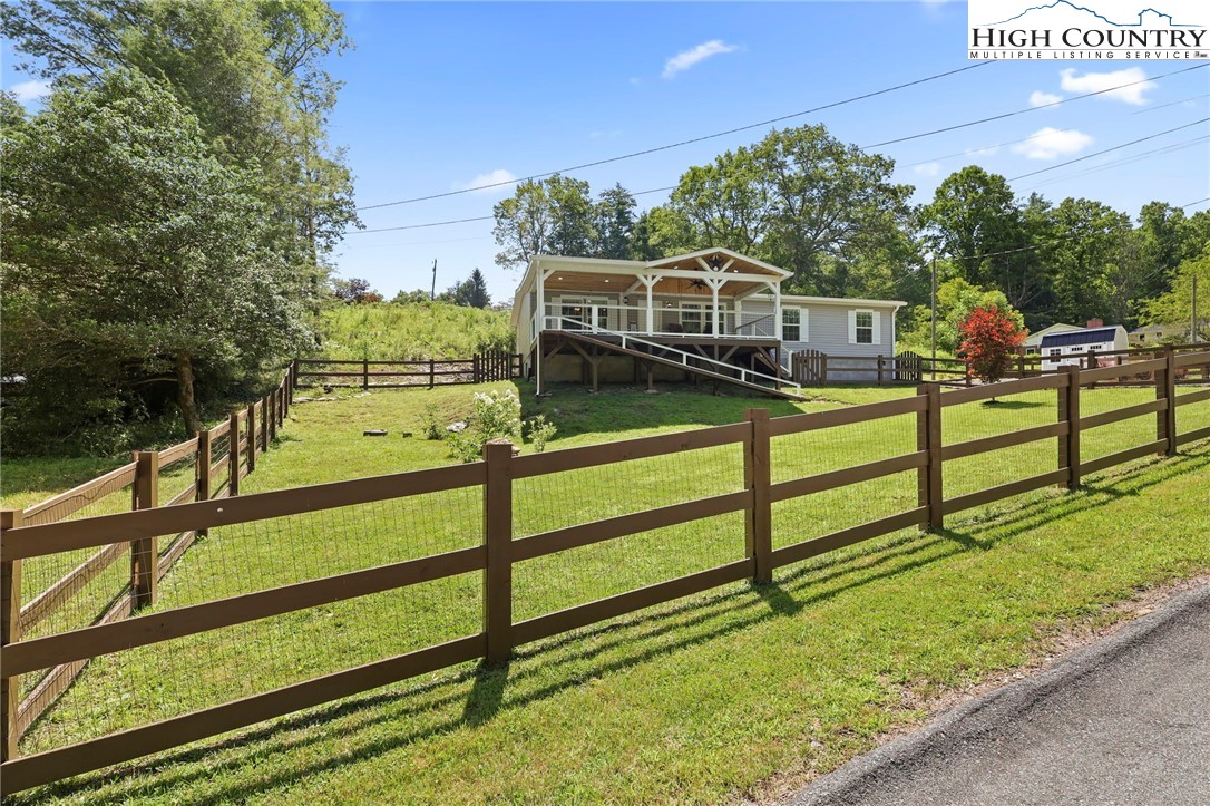 565 Valley Road Spruce Pine, NC 28777 - Photo 2 of 39 a view of a wooden deck and a yard