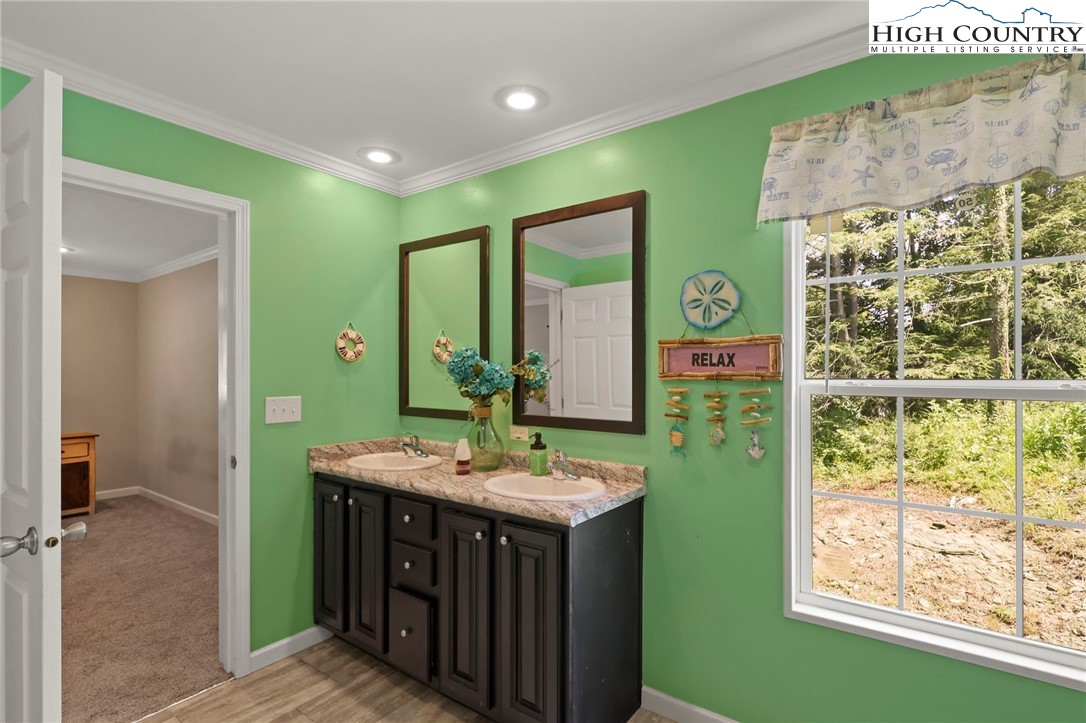 565 Valley Road Spruce Pine, NC 28777 - Photo 25 of 39 a bathroom with a sink mirror and a bathtub