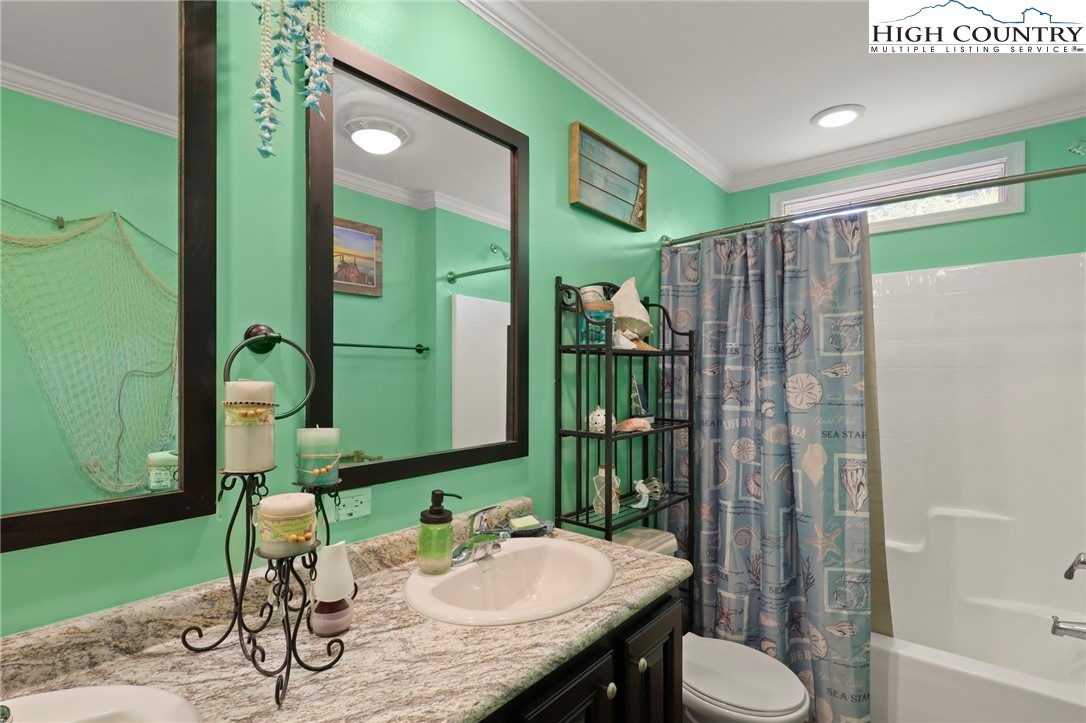 565 Valley Road Spruce Pine, NC 28777 - Photo 28 of 39 a bathroom with a sink a toilet and shower