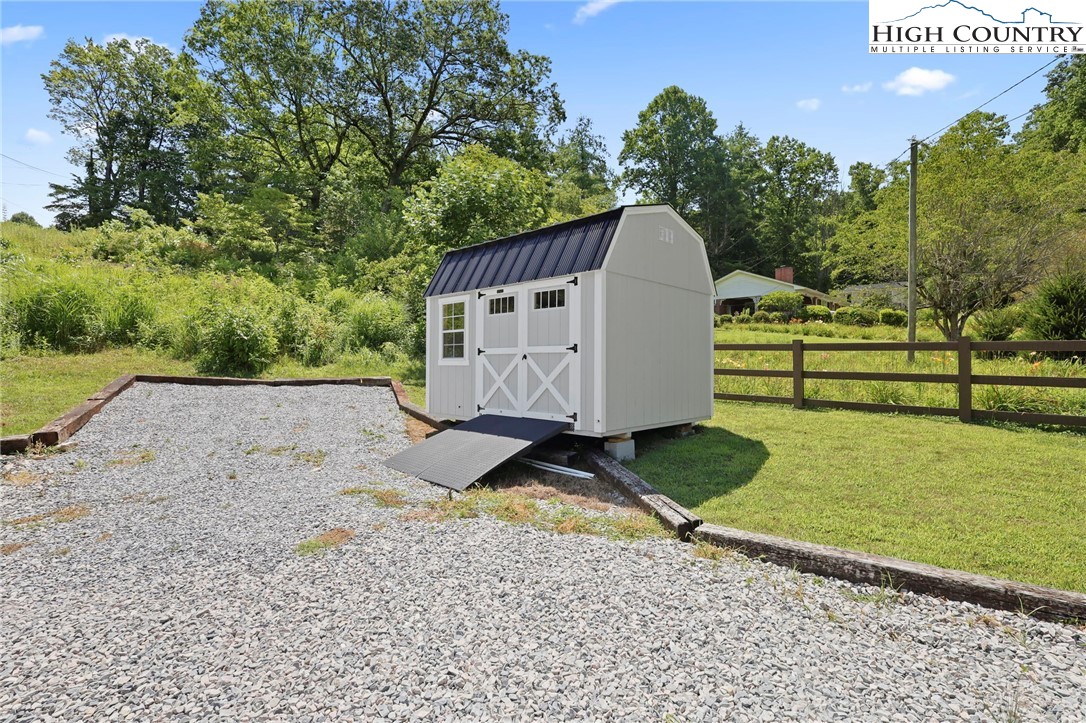 565 Valley Road Spruce Pine, NC 28777 - Photo 34 of 39 a view of a backyard with barn and large trees