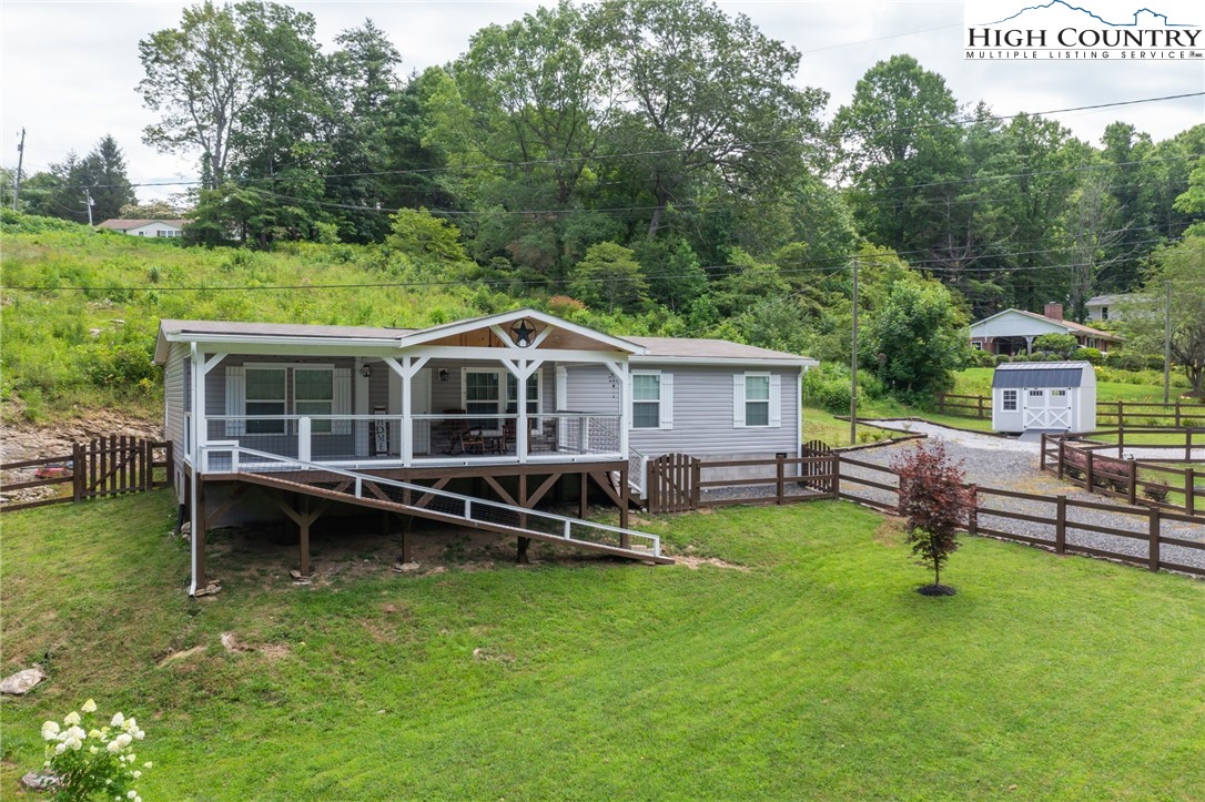 565 Valley Road Spruce Pine, NC 28777 - Photo 35 of 39 a view of a house with a yard and sitting area
