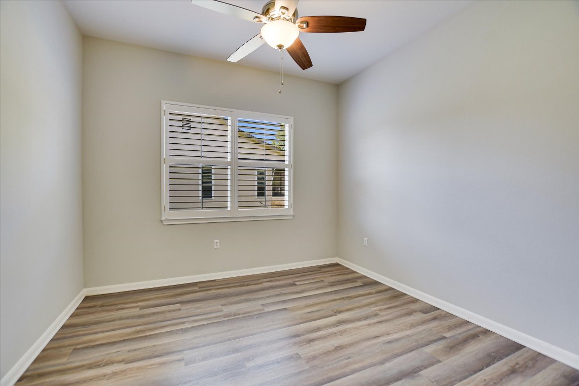 126 Bass Street Georgetown, TX 78633 - Photo 16 of 20 Unfurnished room with light wood finished floors and a ceiling fan