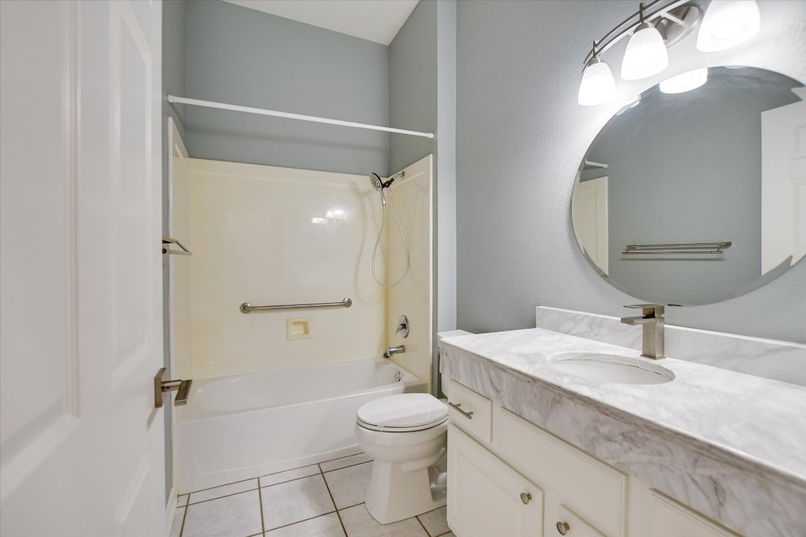 126 Bass Street Georgetown, TX 78633 - Photo 17 of 20 Bathroom with shower / washtub combination, light tile patterned flooring, and vanity