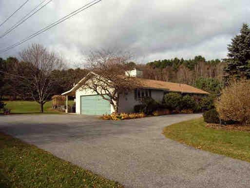 77 Swamp Road West Stockbridge, MA 01266 - Photo 3 of 6 a view of a house next to a yard with large trees