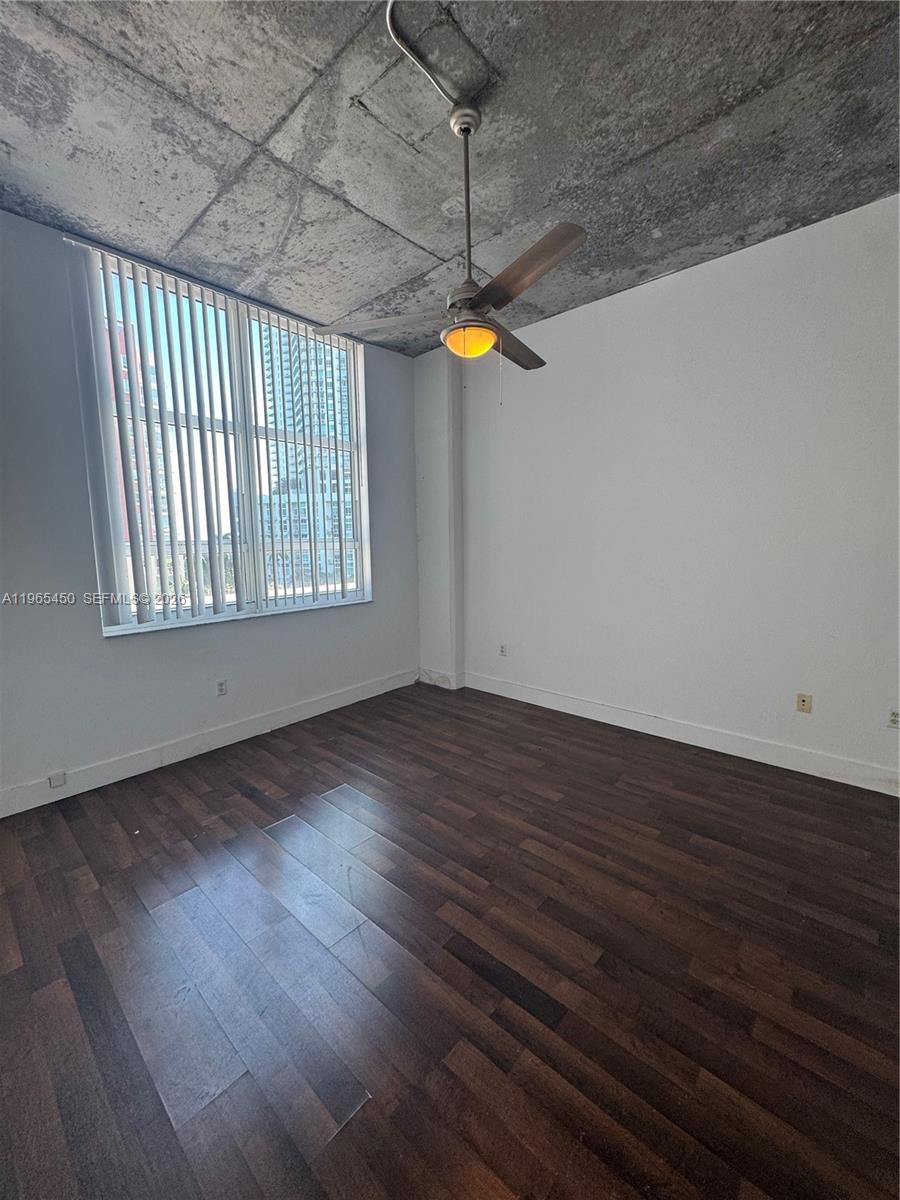 2001 Biscayne Boulevard, Unit 2621 Miami, FL 33137 - Photo 11 of 23 an empty room with wooden floor and windows