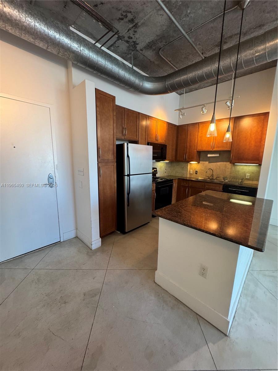 2001 Biscayne Boulevard, Unit 2621 Miami, FL 33137 - Photo 4 of 23 a view of kitchen with stainless steel appliances granite countertop a sink and a refrigerator