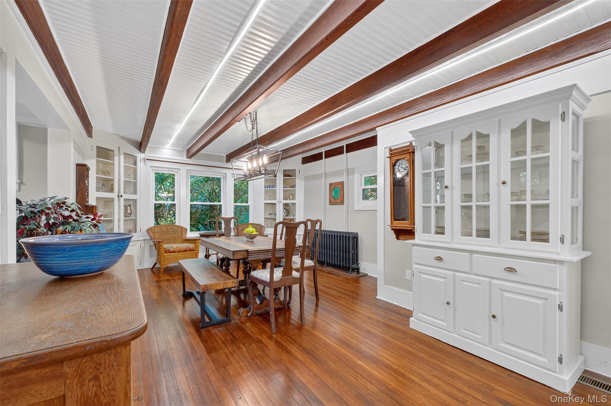 30 Old Post Road North Red Hook, NY 12571 - Photo 11 of 39 Dining space with beam ceiling, dark wood-type flooring, radiator heating unit, and a chandelier